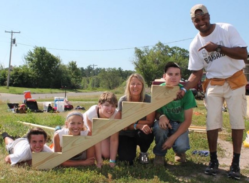 Group Smiling by newly built stairs