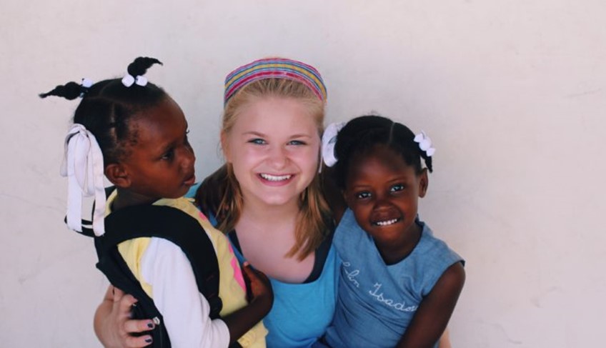 Worker with 2 African children